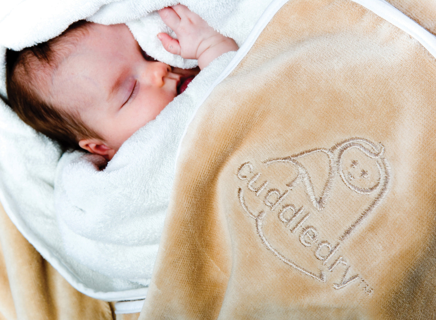 sleeping newborn baby in soft Cuddledry baby towel